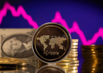 FILE PHOTO: A representations of cryptocurrency Ripple is seen in front of a stock graph and U.S. dollar in this illustration taken, January 24, 2022. REUTERS/Dado Ruvic/Illustration/File Photo