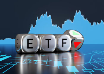 Silver metallic dice showing the alphabets ETF and an up and down arrow on backgrounds of stock charts. Illustration of the concept of investment of exchange-traded funds